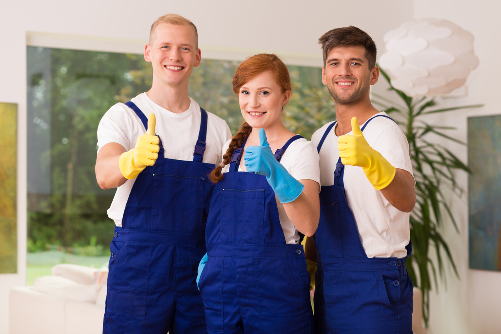 three cleaners giving the thumbs up